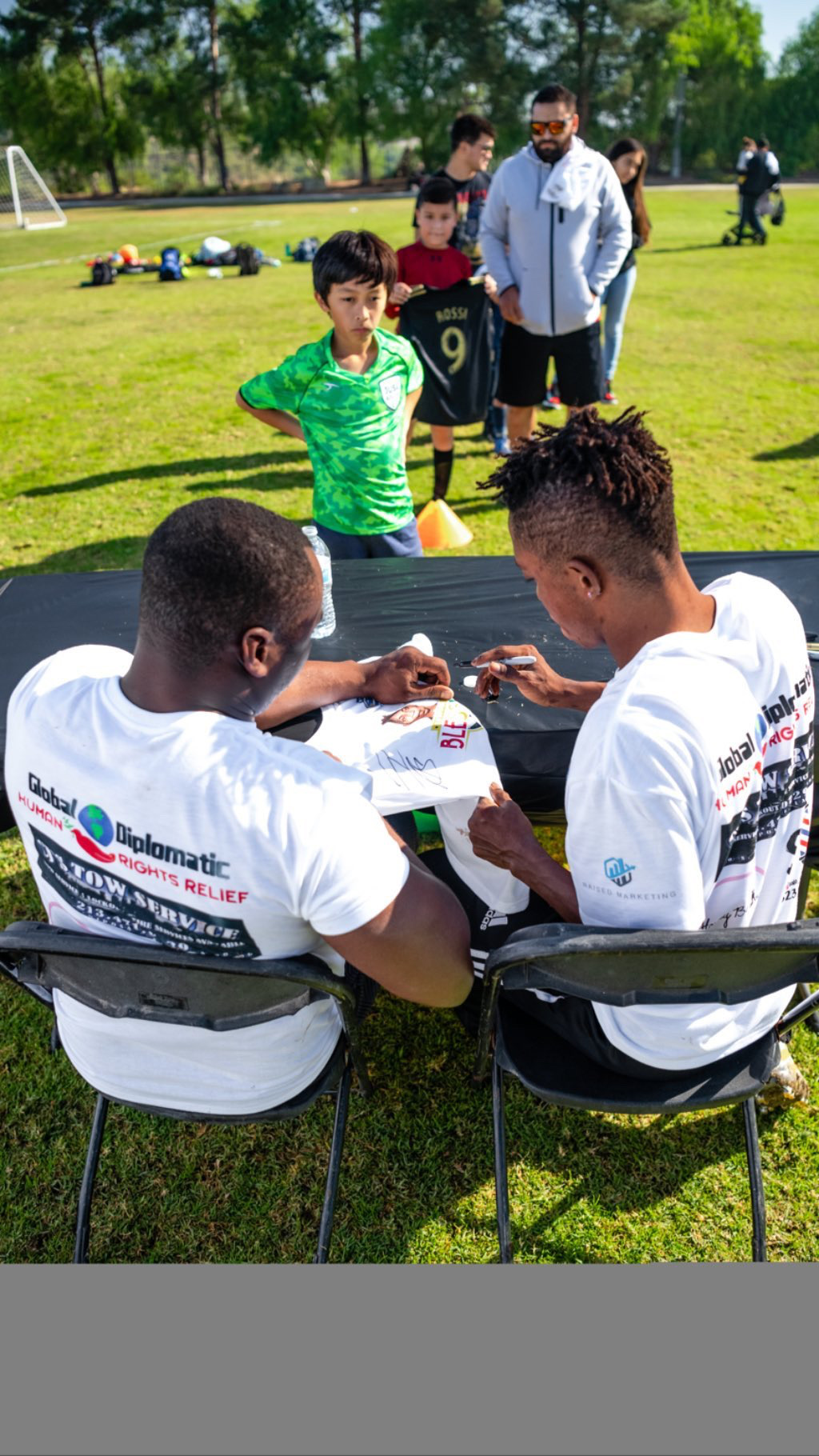 A young player receives a signed football shirt during the event