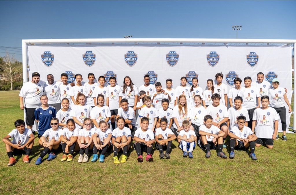 Youth football participants and coaches at a California community event