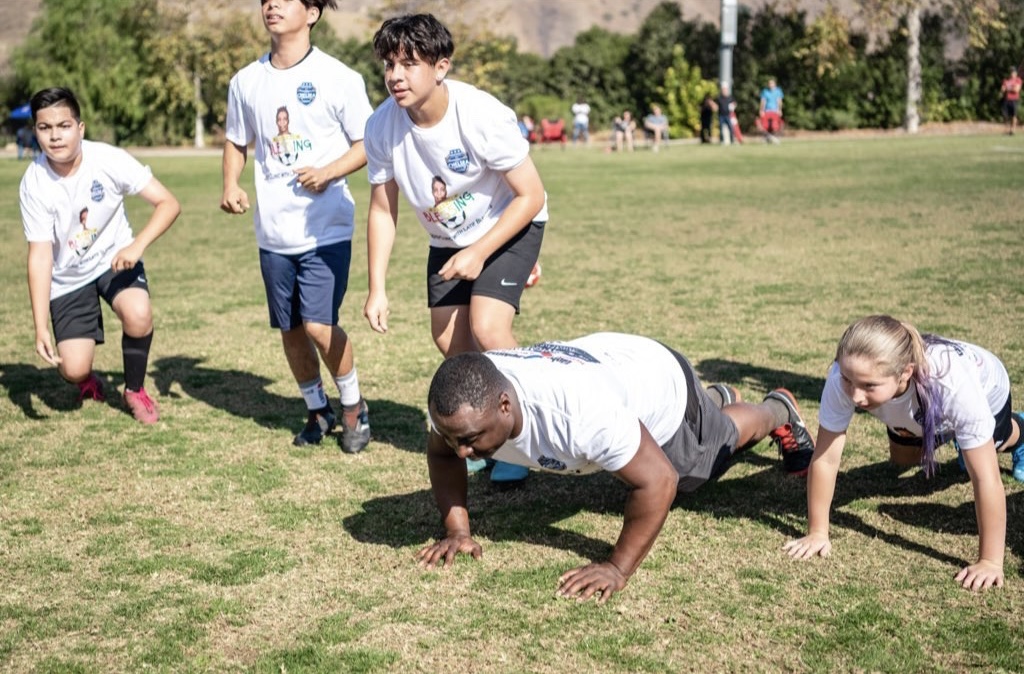 Young athletes take part in football training